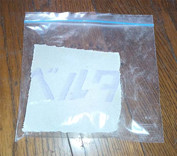 アスベスト試料:石こうボードの試料、10cm四角形で切り出して密閉袋に入れている